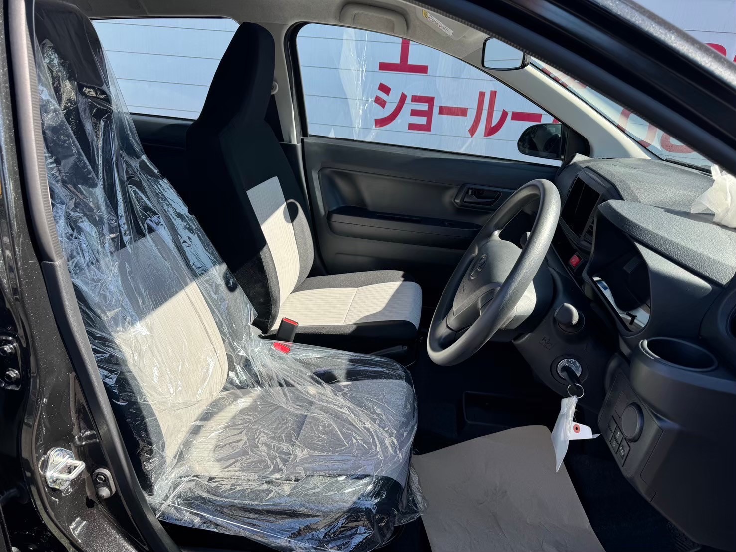 トヨタピクシスエポックの運転席、新車の内装、プラスチックカバー付き